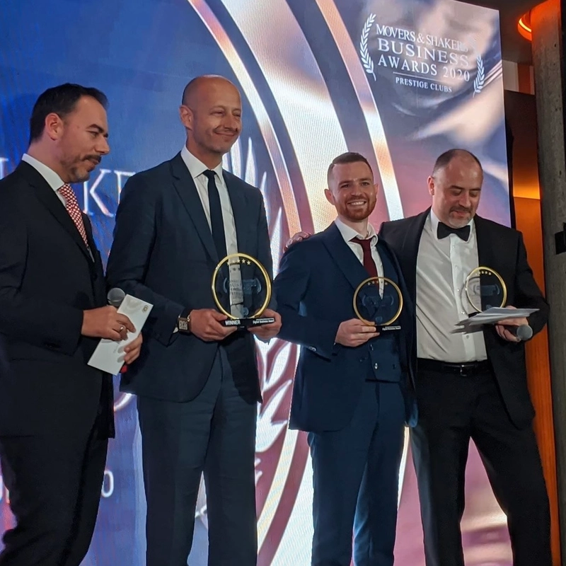 Chris Rowan at the Movers and Shakers Business Awards ceremony with colleagues, all holding trophies